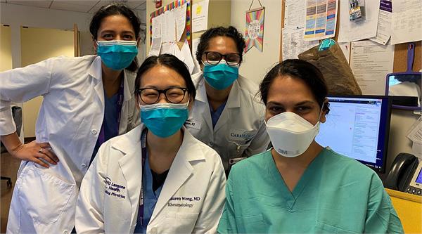 Hemali Patel, MD, (in green scrubs), a hospitalist with the University of Texas at Austin Dell Medical School, poses with her team at NYU Langone Health. Patel spent a week volunteering to care for patients at NYU Langone.